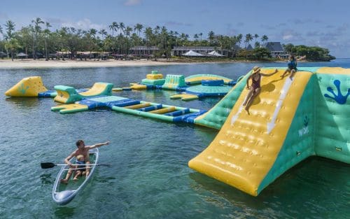 Shangri-la Fijian Resort & Spa Family fun on the inflatable waterpark off Lagoon Beach