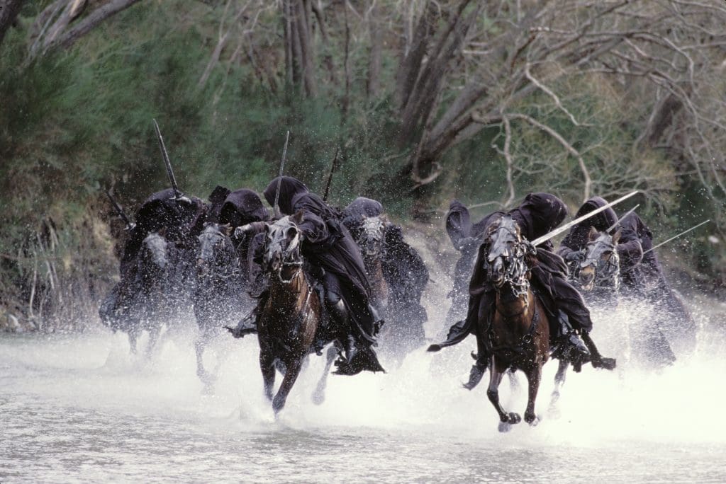 Lord of the Rings Riders in Ringwraith costumes on horseback filming the Ford of Buinen sequence on location near Arrowtown. PC ©2021 WBEI