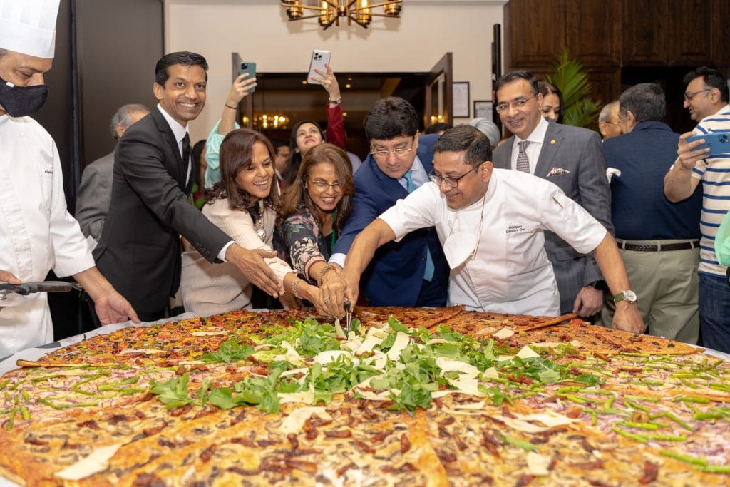 The very first 108 inch commercially viable pizza ever made at President Mumbai 1 Slicing the 108 inch commercially viable pizza at the relaunch of the Trattoria at President, Mumbai – IHCL SeleQtions.