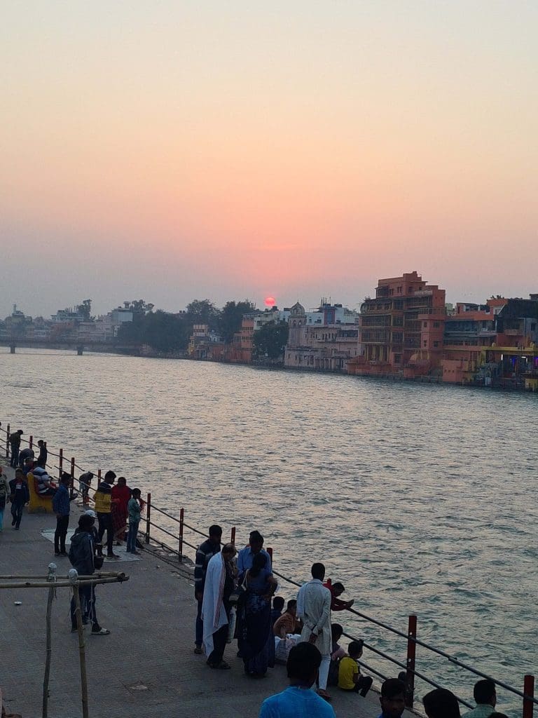 Visit Rishikesh and Haridwar 
Moments-of-contemplation-for-pilgrims-and-visitors-alike-as-the-Ganga-waters-flow-fast-and-a-red-sun-sets-at-the-Ghats-of-Haridwar