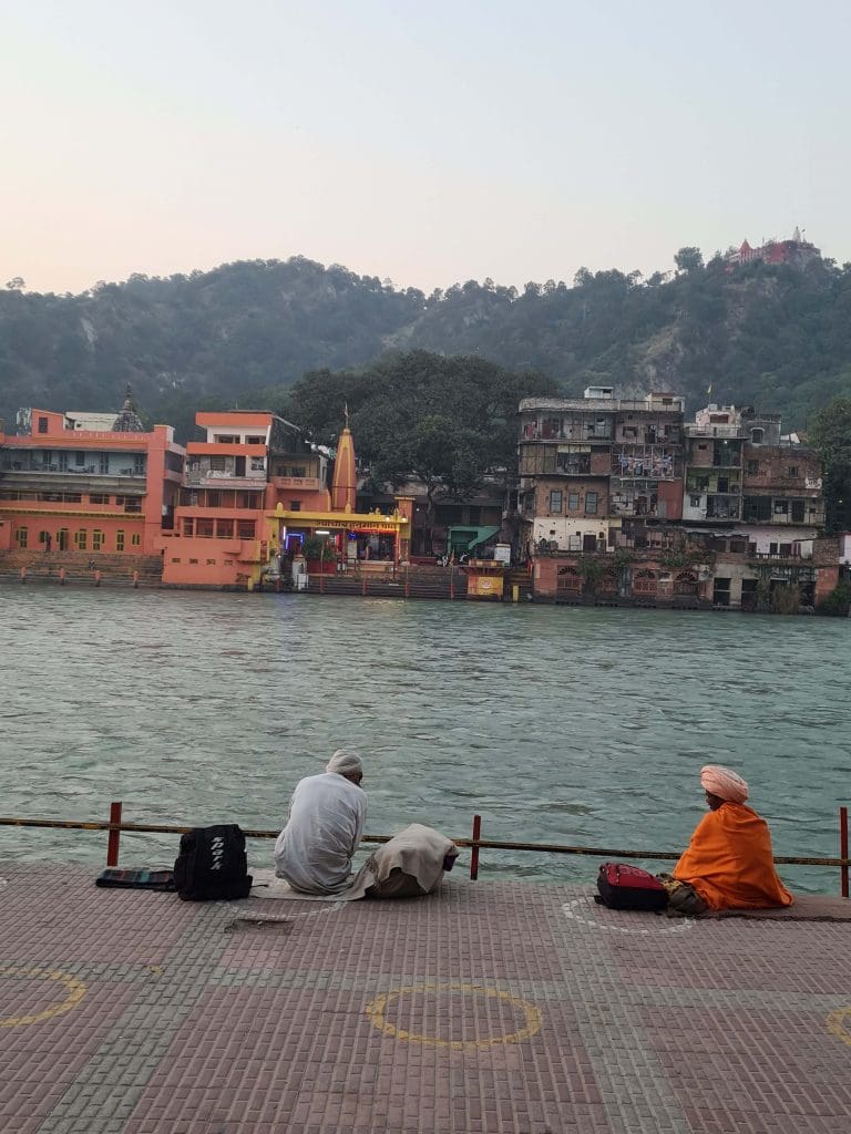 Rishikesh and Haridwar - top trips of 2022 for epic faith and spiritual calling 28 Visit Rishikesh and Haridwar
Seeker-and-sage-in-comfortable-silence-while-the-Ganga-waters-flow-and-temple-bells-ring-across-the-Ghat
