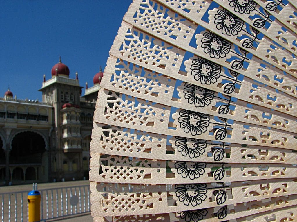 A sandalwood fan, with the Mysore Palace in the background Image courtesy Hrishikesh Premkumar via Flickr