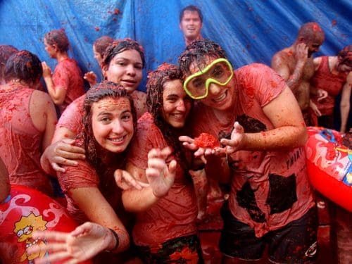 La Tomatina is a food fight festival held in Buñol in the Valencia region of Spain. Image Courtesy flydime via Wikipedia Commons