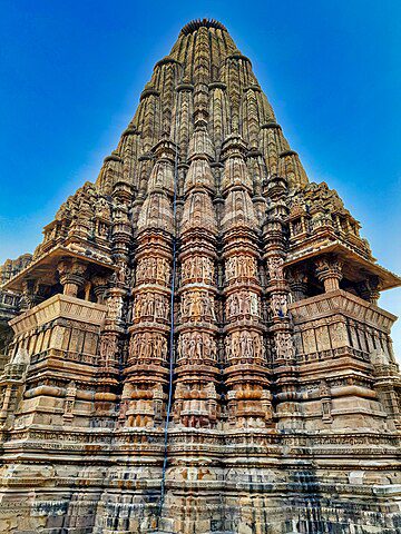 The Kandariya Mahadeva temple of Khajurajo is a Shiva temple (1025–1035 CE). It is the largest and tallest surviving temple in the Khajuraho group of monuments. Image courtesy: Ms Sarah Welch via Wikipedia Commons