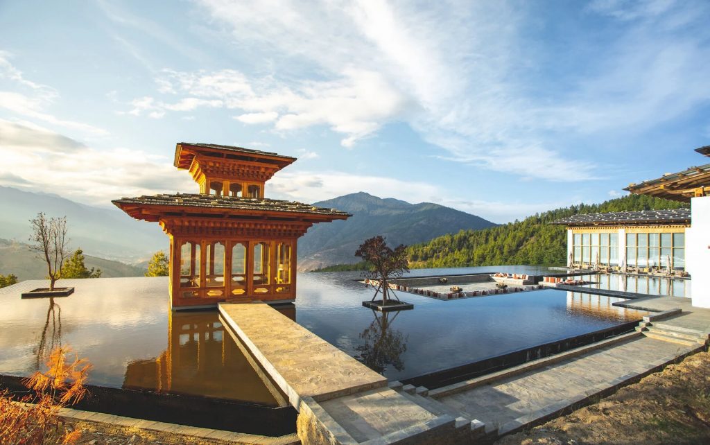 Overlooking paddy fields with farmers -Six Senses Bhutan - Eco Luxe Escapes