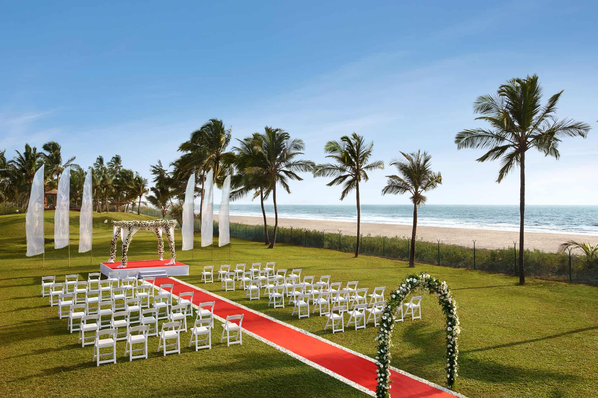 The beachfront lawn of Caravela Beach Resort is a favourite among couples