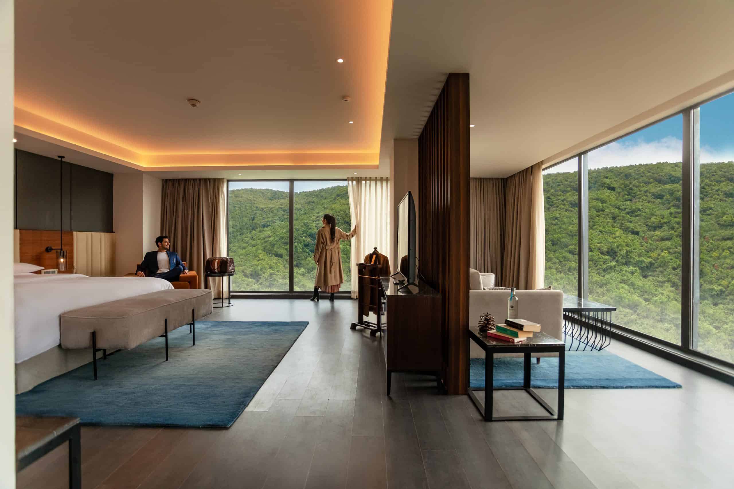 Each room features expansive windows, private balconies in many cases, smart televisions and high speed WiFi, all set against a backdrop of pine fringed ridges.