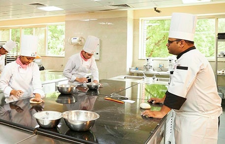 Students at The Lalit Suri Hospitality School receive hands-on industry training as part of their certified hospitality programs with 100% placement assurance.