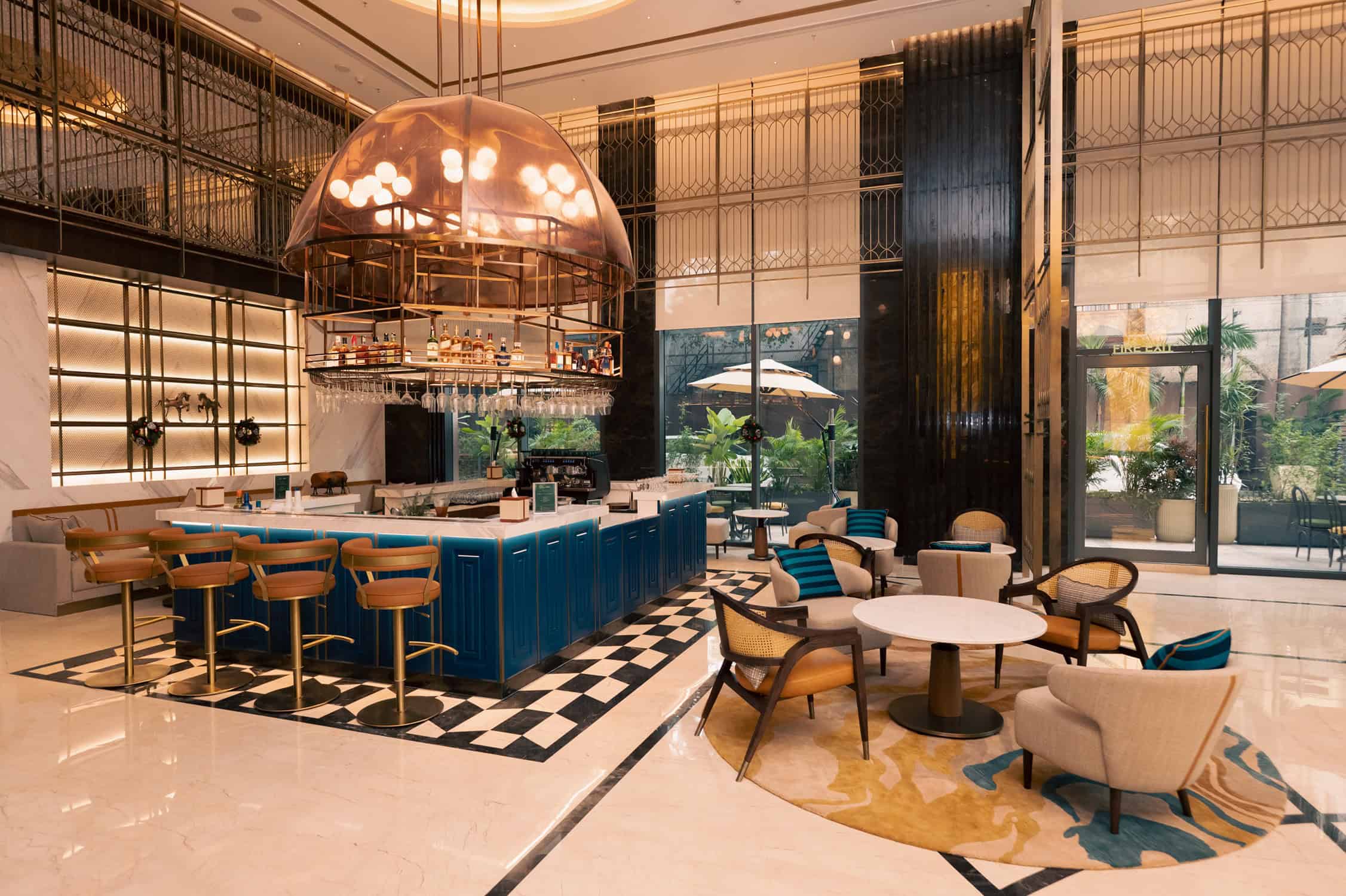 The reimagined R Bar at Renaissance Bengaluru Race Course Hotel, featuring its striking polo-inspired dome, elegant blue bar counter, and contemporary seating