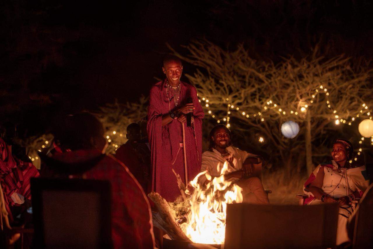 Samburu cultural storytellers share indigenous sky wisdom around a glowing bonfire at Samburu Sopa Lodge, bringing the Astro Tourism Experience to life through traditional narratives and communal warmth.
