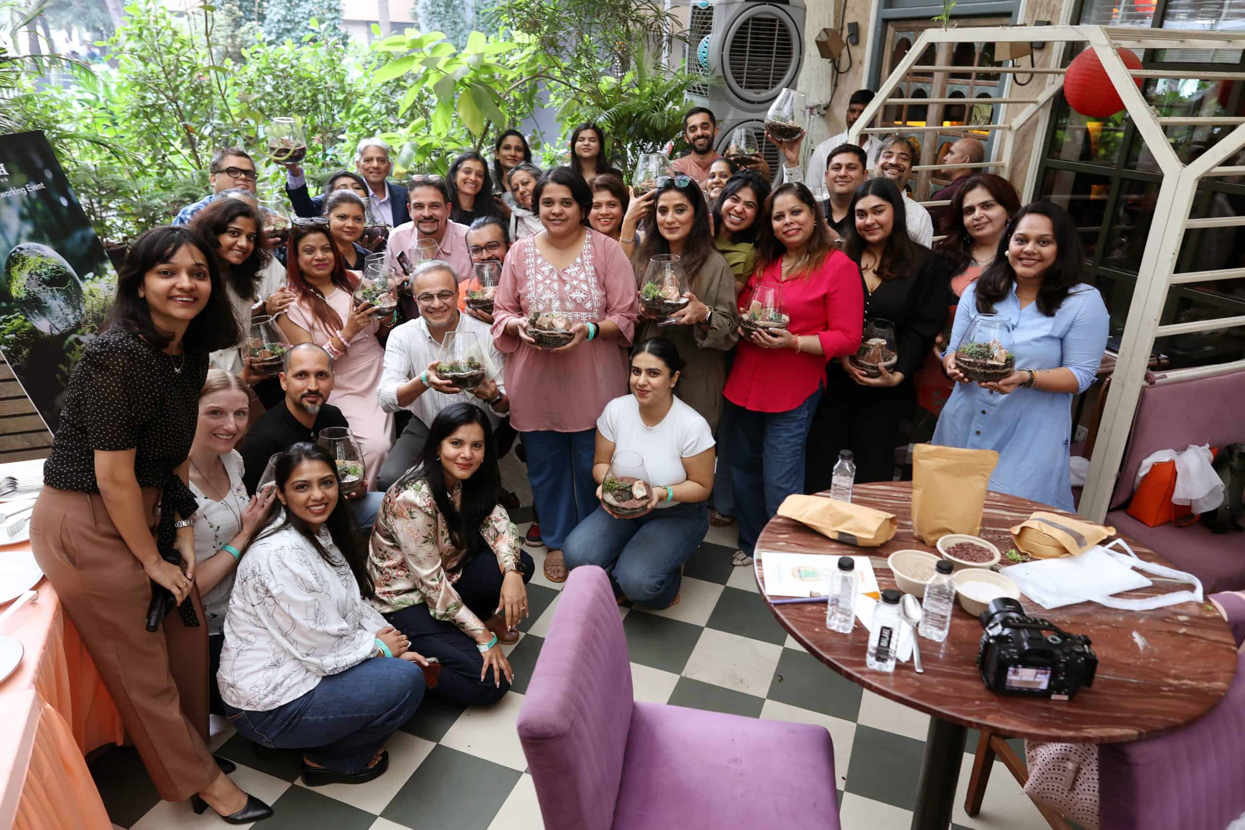 Trade and media partners pose with handcrafted Glass Gardens during the Utah networking experience