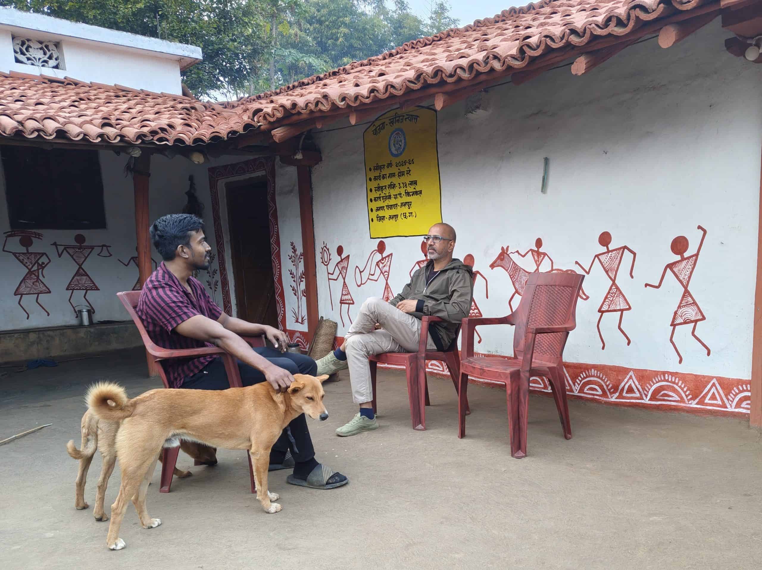 Mahesh from Tamil Nadu with his pet dog Max during his stay at a Homestays of India property in Jashpur, experiencing authentic village life and community hospitality.