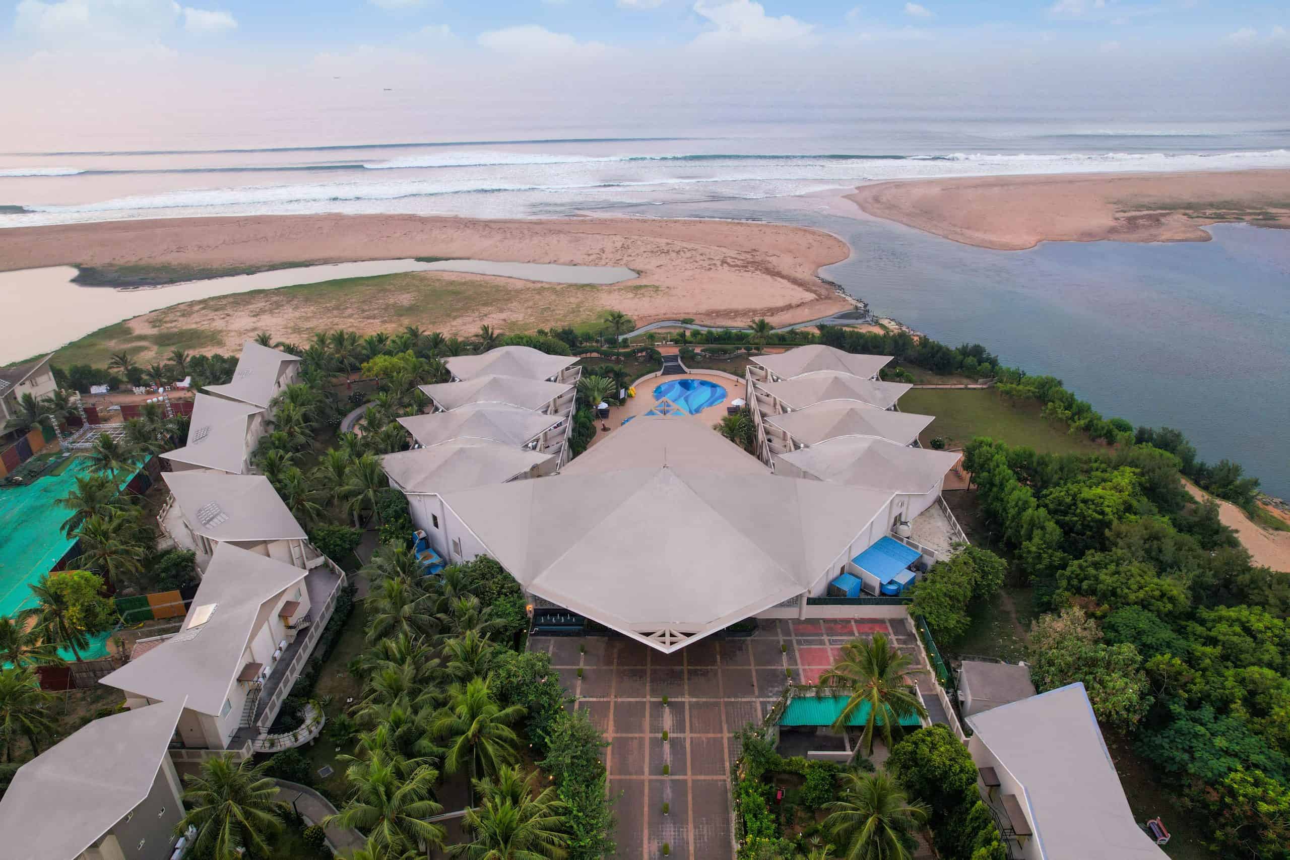 Luxury beachfront resort featuring a private pool, lush gardens, and scenic views of the ocean. Perf.