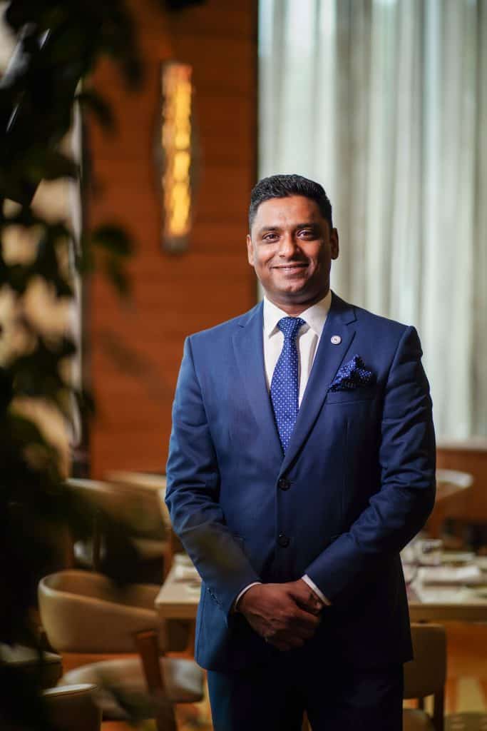 Rijo Varghese in formal suit at Sheraton Bangalore Hotel, new F&B Director.