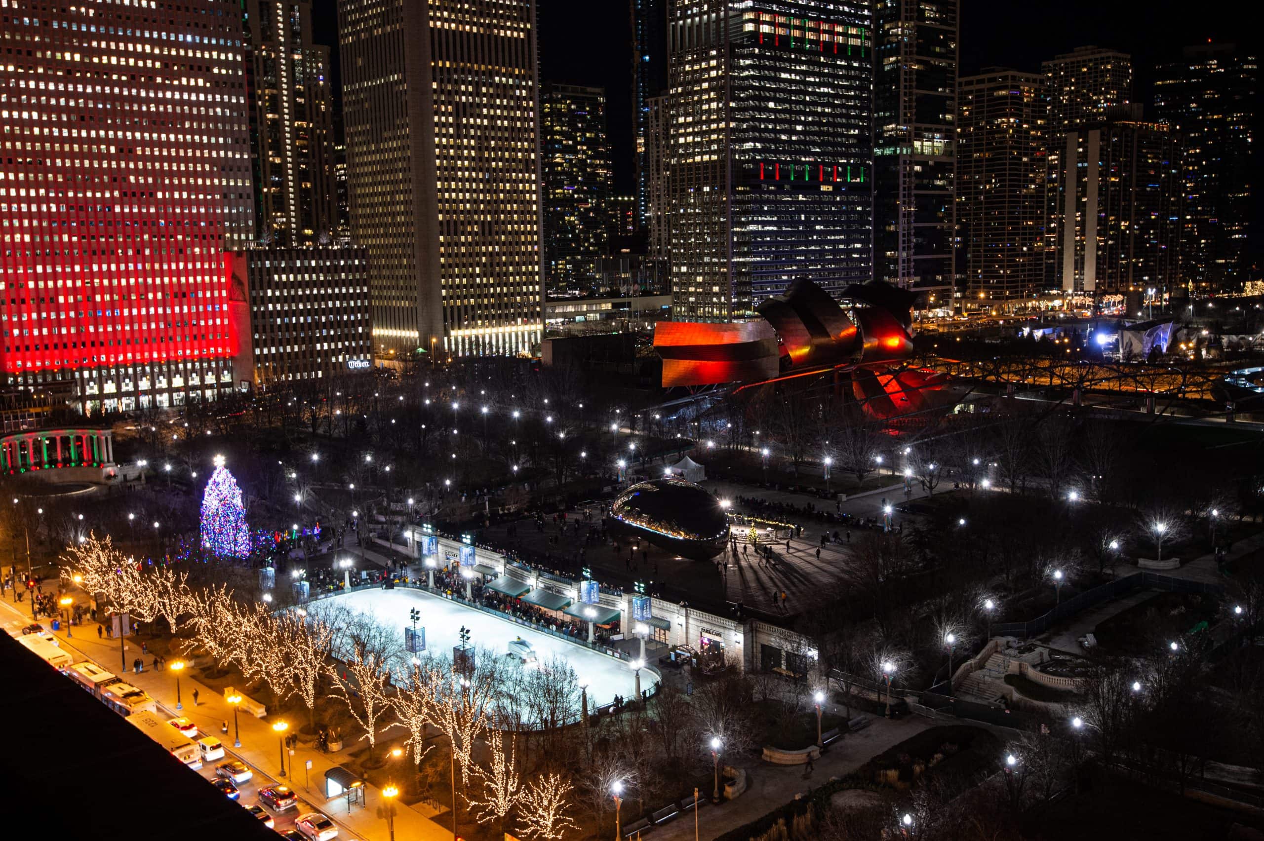 Millennium Park glows on a winter night, with the ice rink, holiday lights, and Chicago skyline sparkling together