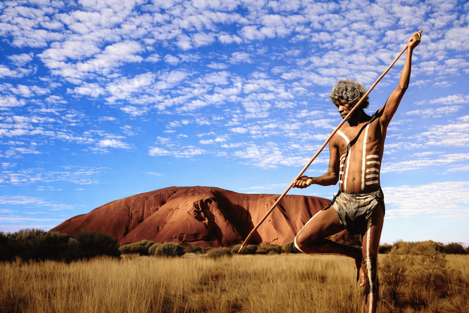 Anangu tribesman in front of Uluru, Australia, indigenous luxury travel