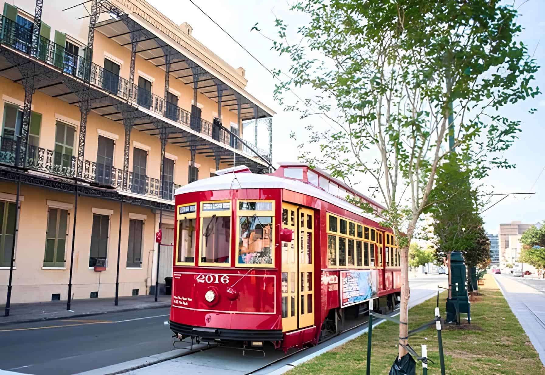 A classic New Orleans streetcar rolls past historic façades, capturing the city’s timeless charm