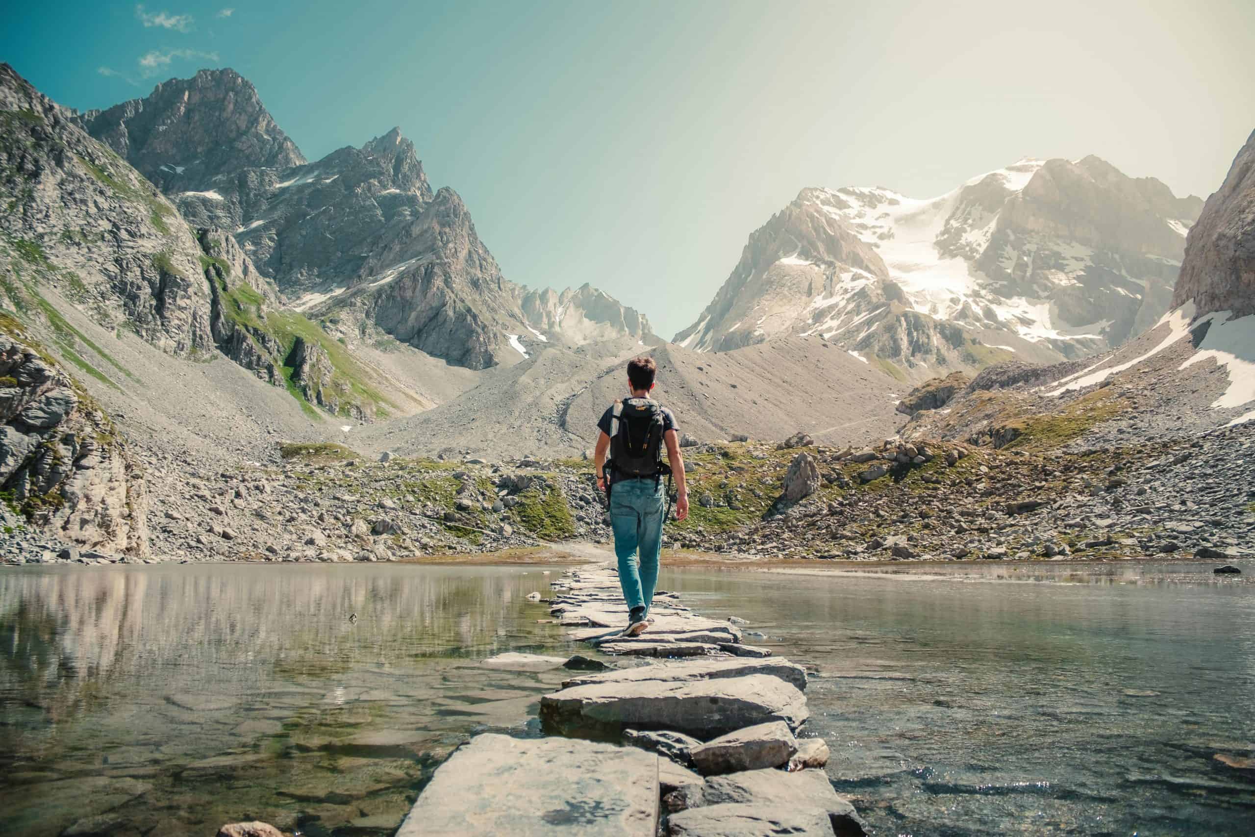 Adventure Travel Across a Footbridge in the Mountains. Image Courtesy: Lorenzo Castellino, Pexels