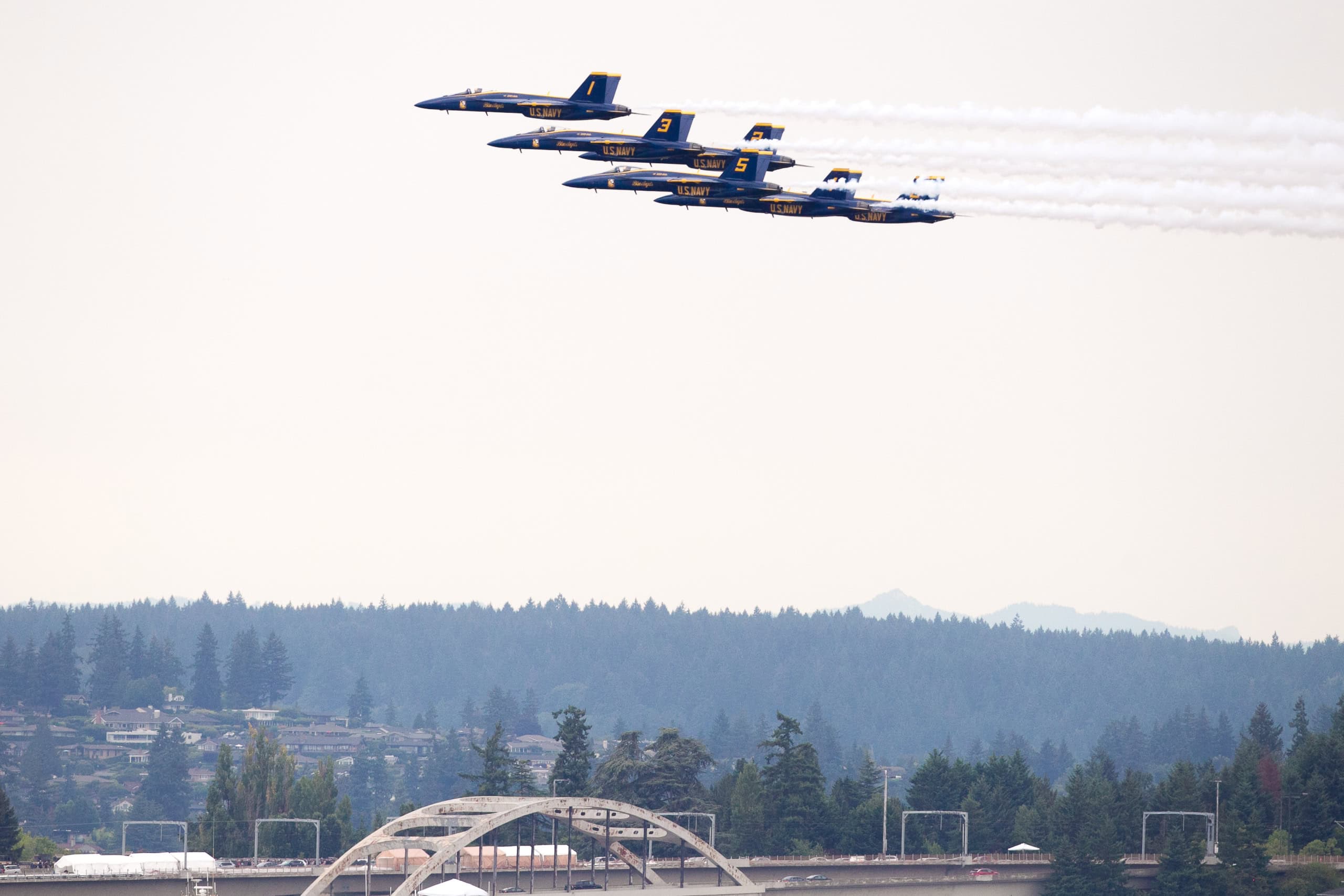 Blue Angels soar above the waterfront during a dramatic air show display
