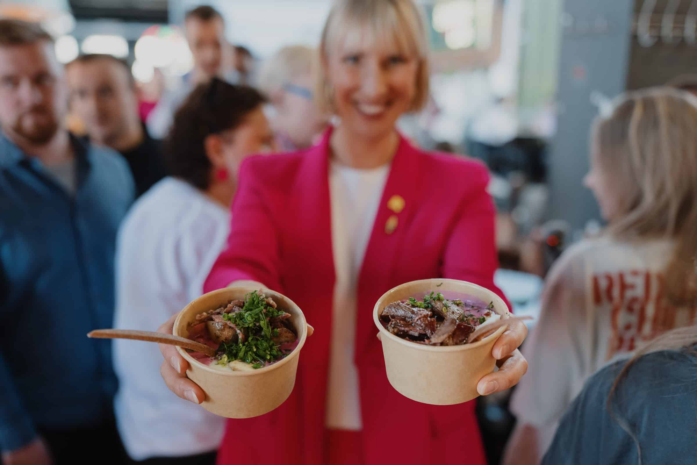Festival-goers serve up bowls of the iconic pink soup as the celebrations turn deliciously vibrant