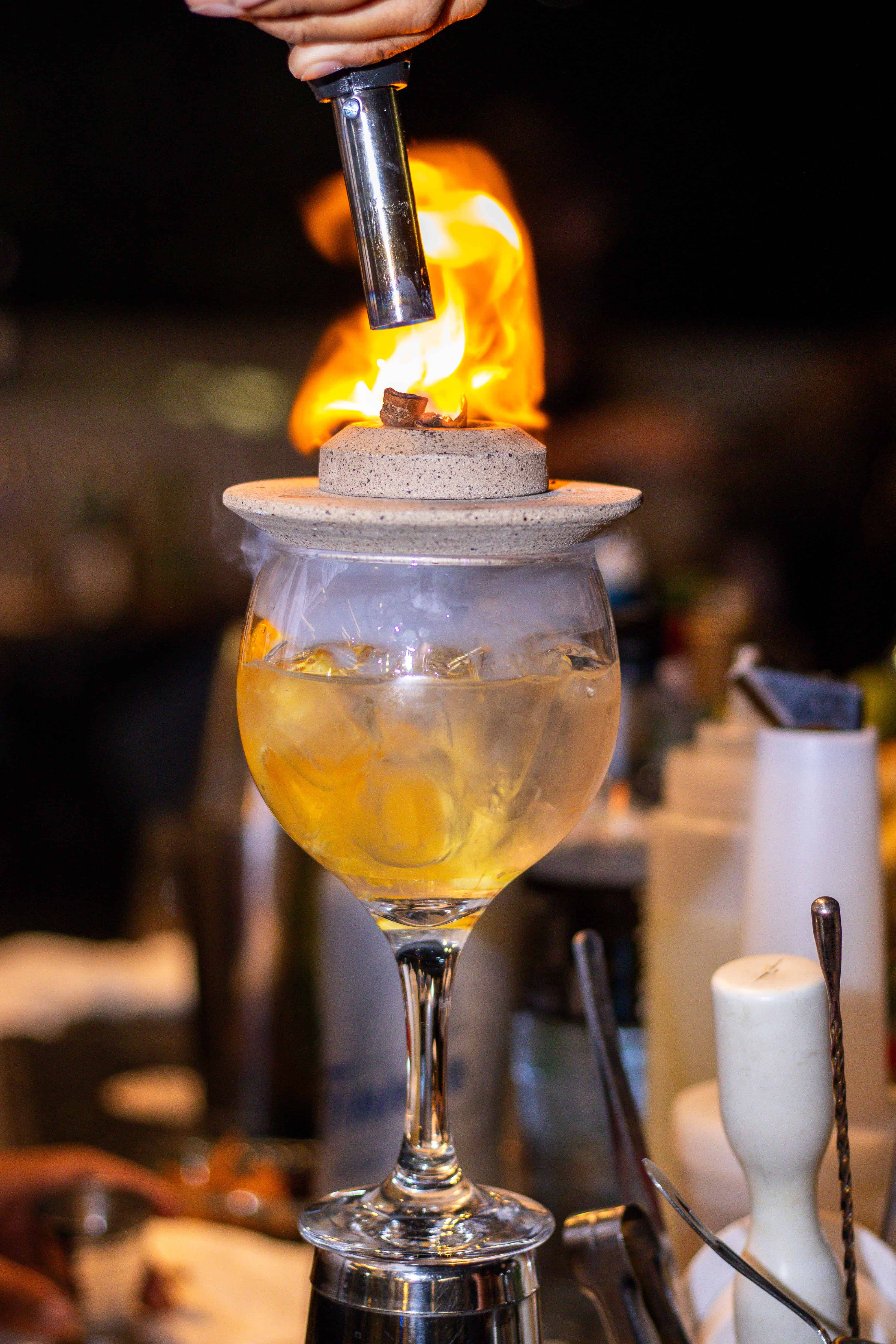 A visually striking cocktail with fiery garnish. Courtesy: William Prado, pexels