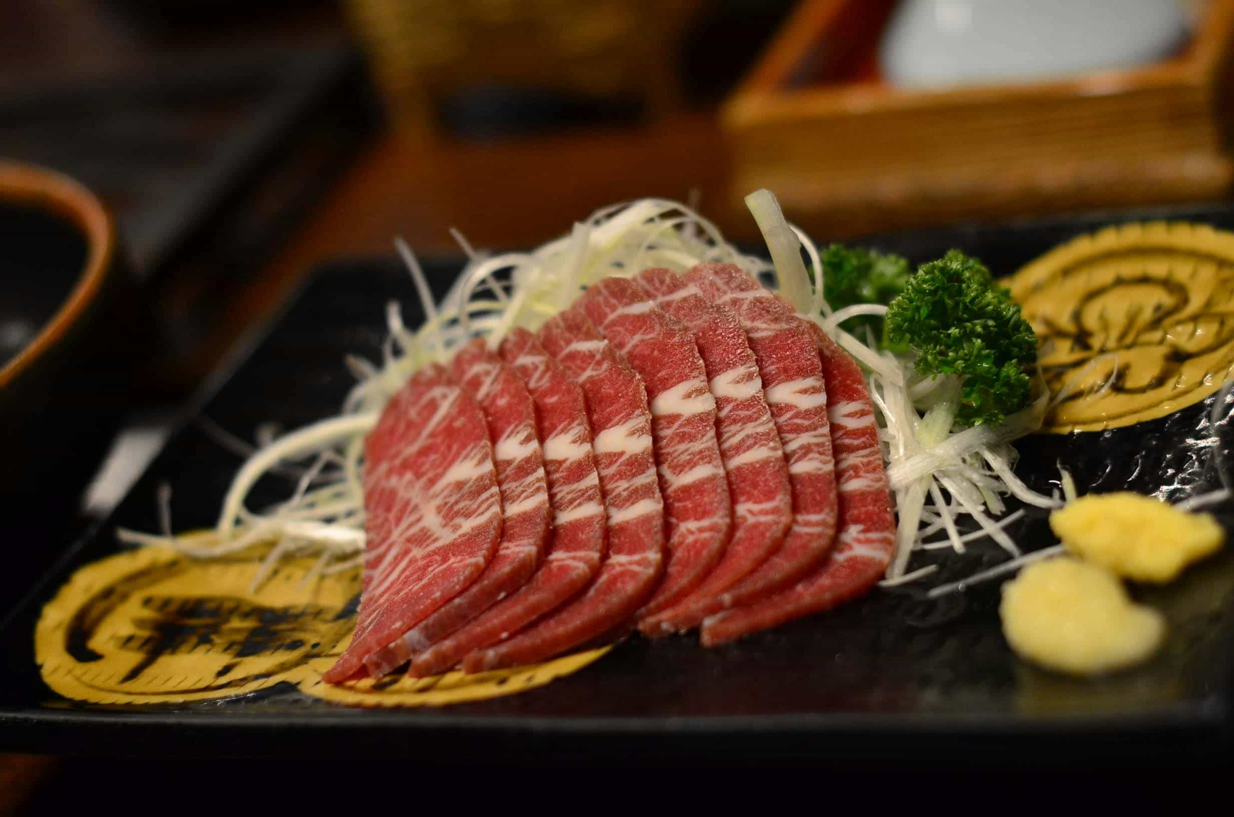 Wagyu beef sashimi with garnish. Courtesy: Jon Discipulo, Pexels