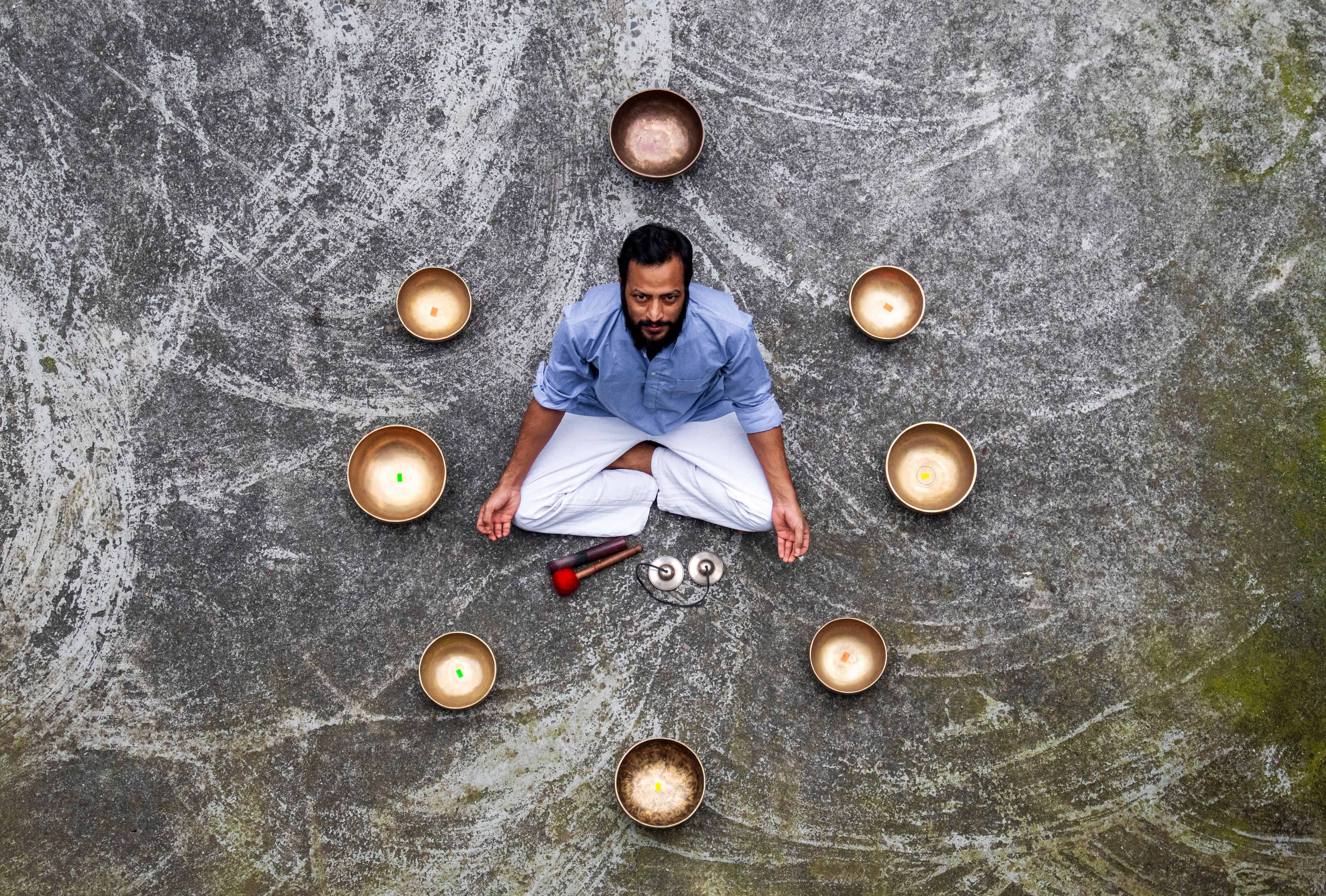 Ayurveda: Man meditating surrounded by singing bowls. Courtesy: Anup Panthi, Pexels