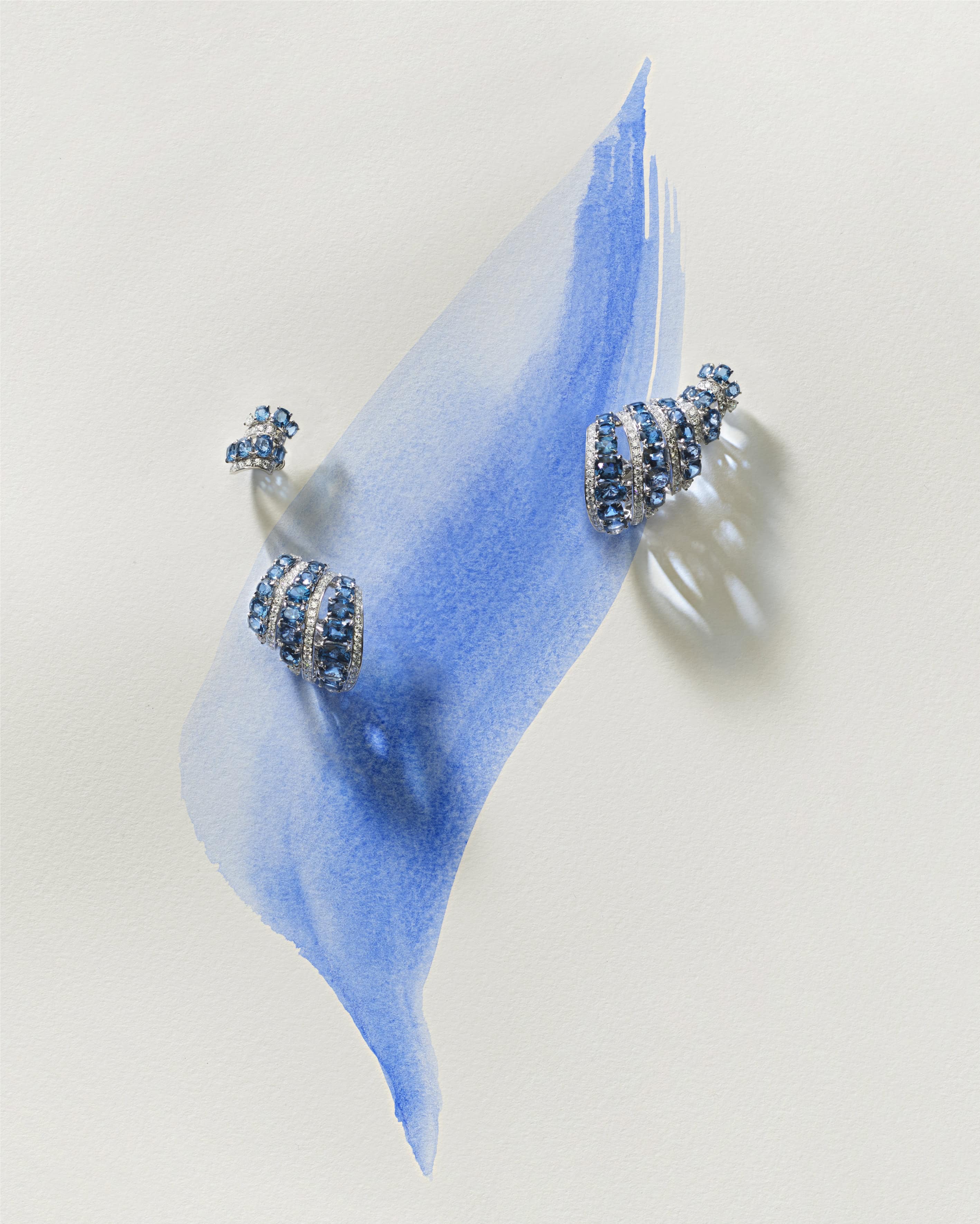 Undara is created in white gold with blue spinels and diamonds.